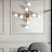 Серия потолочных светодиодных люстр с дисковидными плафонами на тонких угловых штангах латунного оттенка DAHLIA A фото 10